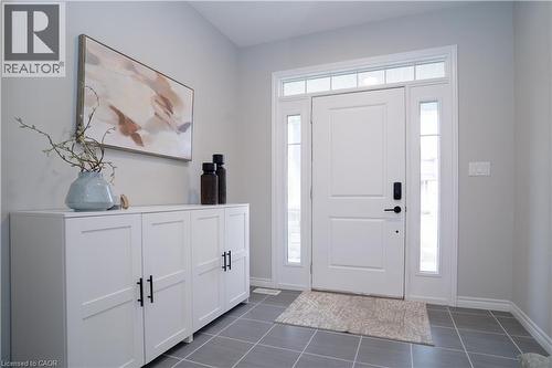 Foyer entrance with dark tile patterned floors and baseboards - 709 Rock Elm Street, Waterloo, ON - Indoor Photo Showing Other Room