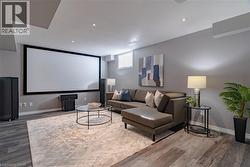 Cinema with wood finished floors and recessed lighting - 