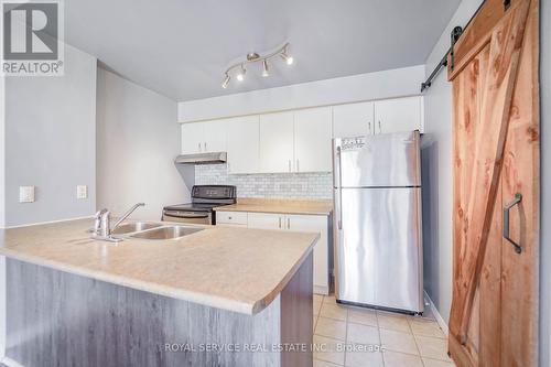 207 - 90 Aspen Springs Drive, Clarington (Bowmanville), ON - Indoor Photo Showing Kitchen With Double Sink