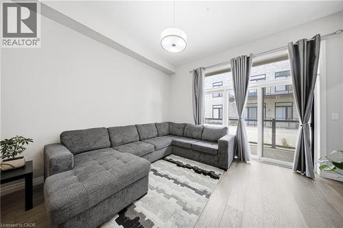 Living area featuring wood finished floors - 85 Morrell Street Unit# 102A, Brantford, ON - Indoor Photo Showing Living Room