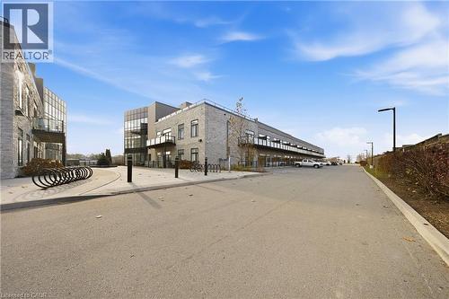 View of asphalt road with street lights and curbs - 85 Morrell Street Unit# 102A, Brantford, ON - Outdoor