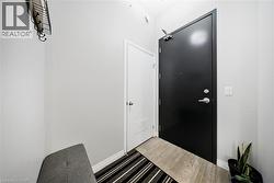 Foyer entrance featuring wood finished floors and baseboards - 
