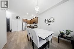 Dining space featuring light wood-style flooring and recessed lighting - 