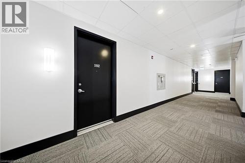 Hallway featuring carpet floors, recessed lighting, and a paneled ceiling - 85 Morrell Street Unit# 102A, Brantford, ON - Indoor Photo Showing Other Room