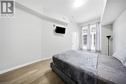 Bedroom with baseboards and wood finished floors - 