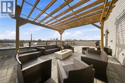 View of patio / terrace featuring a pergola and an outdoor living space with a fire pit - 