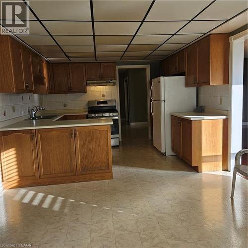 Kitchen with extractor fan, stainless steel range, kitchen peninsula, and sink - 115 Cranston Avenue, Cambridge, ON - Indoor Photo Showing Kitchen