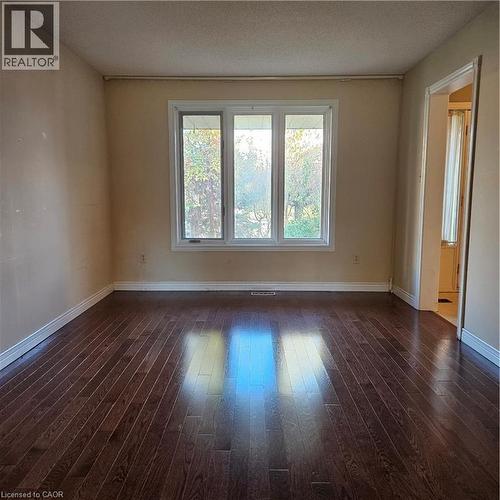 Unfurnished room with dark hardwood / wood-style floors and a textured ceiling - 115 Cranston Avenue, Cambridge, ON - Indoor Photo Showing Other Room