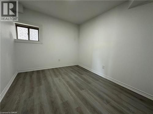 Spare room with dark wood-type flooring - 88 Bellhouse Avenue Unit# Bsmt, Brantford, ON - Indoor Photo Showing Other Room