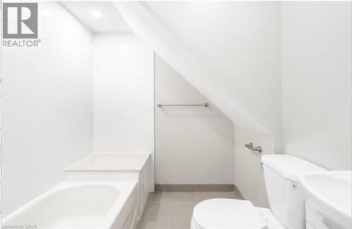 Bathroom with toilet and light tile patterned floors - 102 Wellington Street N Unit# 2, Hamilton, ON - Indoor Photo Showing Bathroom