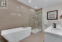 Ensuite soaker tub; rainhead shower has body spray - 