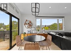 Open dining space with direct sightlines to both the kitchen and outdoor living area. - 