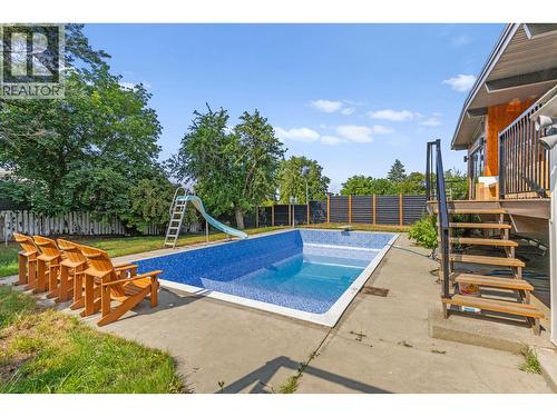Private fully fenced yard with a heated inground pool and all-day sun exposure. - 1511 Lambert Avenue, Kelowna, BC - Outdoor With In Ground Pool With Backyard