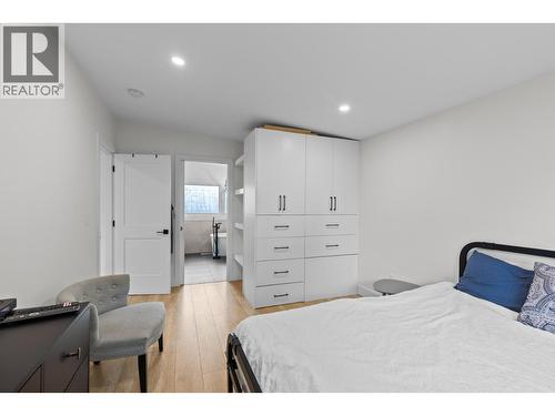Built in closets provide efficient, streamlined storage while keeping the primary bedroom feeling spacious and tidy. - 1511 Lambert Avenue, Kelowna, BC - Indoor Photo Showing Bedroom