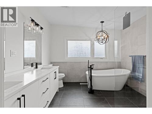 Luxury spa-like ensuite with walk-in tile shower, freestanding tub, and dual vanity. - 1511 Lambert Avenue, Kelowna, BC - Indoor Photo Showing Bathroom