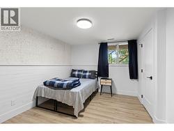 Comfortable bedroom in the in-law suite with natural light. - 