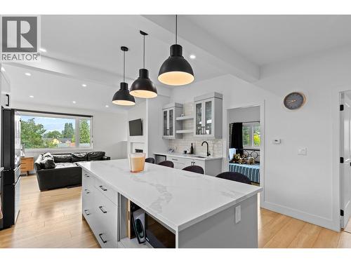 Bright open-concept living area with large windows and seamless flow into the kitchen and dining space. - 1511 Lambert Avenue, Kelowna, BC - Indoor Photo Showing Kitchen With Upgraded Kitchen