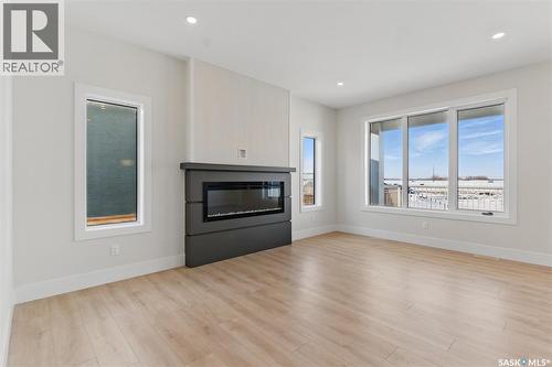 218 Veterans Drive, Warman, SK - Indoor Photo Showing Living Room With Fireplace