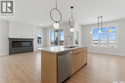 218 Veterans Drive, Warman, SK - Indoor Photo Showing Kitchen With Fireplace With Double Sink