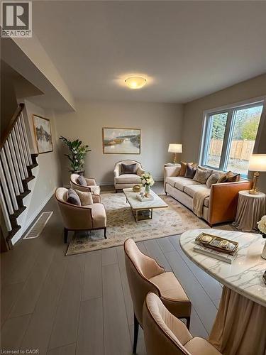 Living area featuring stairs and wood finished floors - 12 Riddell Drive, Stratford, ON - Indoor Photo Showing Living Room