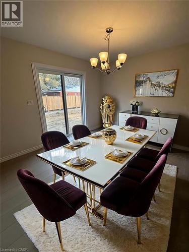 Dining space with baseboards and a chandelier - 12 Riddell Drive, Stratford, ON - Indoor Photo Showing Dining Room