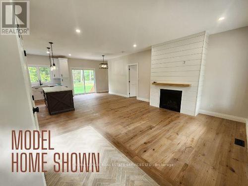 99 Tall Pines Drive, Tiny, ON - Indoor Photo Showing Living Room With Fireplace