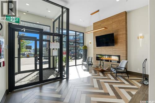 220 105 Willis Crescent, Saskatoon, SK - Indoor Photo Showing Other Room With Fireplace