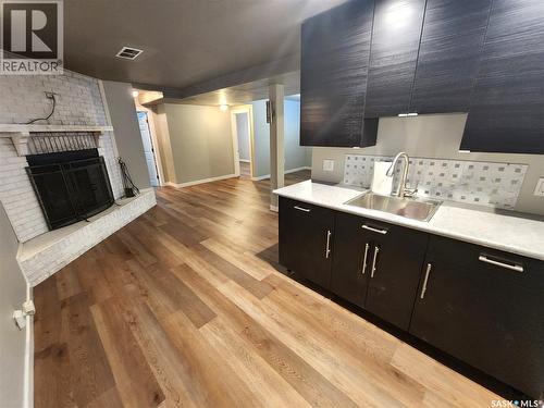 1533 Young Street, Estevan, SK - Indoor Photo Showing Kitchen With Fireplace With Double Sink