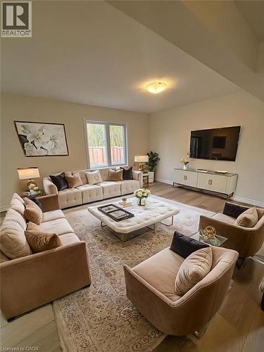 Living area featuring light wood-style floors and baseboards - 4 Riddell Drive, Stratford, ON - Indoor Photo Showing Living Room