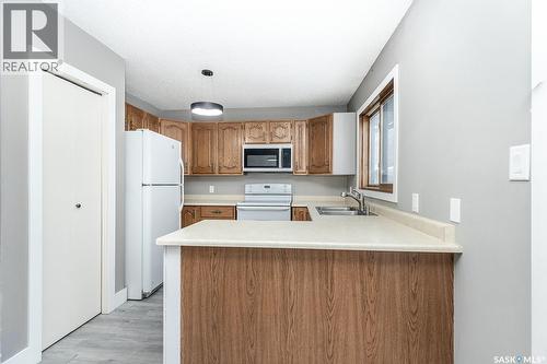 354 Allegretto Crescent, Saskatoon, SK - Indoor Photo Showing Kitchen With Double Sink