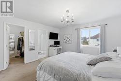 primary bedroom with walk in closet and ensuite ba - 