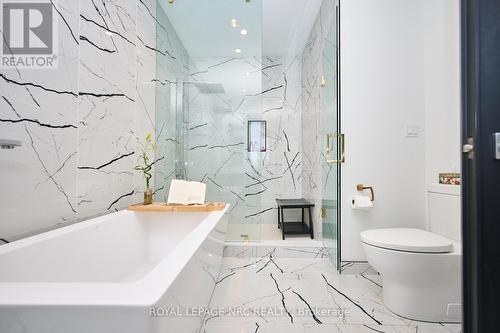 Soaker tub, glass-enclosed shower, gold accents - 10 Pawling Street, St. Catharines (Port Dalhousie), ON - Indoor Photo Showing Bathroom