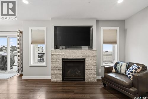 5669 Glide Crescent, Regina, SK - Indoor Photo Showing Living Room With Fireplace