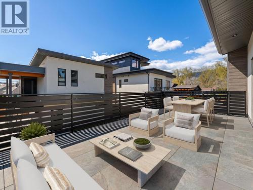 VIRTUALLY STAGED WITH FURNITURE ON PRIMARY BEDROOM DECK - 700 Churchill Avenue, Penticton, BC - Outdoor With Deck Patio Veranda