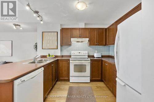 Photo has been digitally staged - 309 - 145 Third Street, Cobourg, ON - Indoor Photo Showing Kitchen With Double Sink