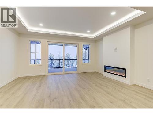 2115 Montenegro Drive, Kelowna, BC - Indoor Photo Showing Other Room With Fireplace