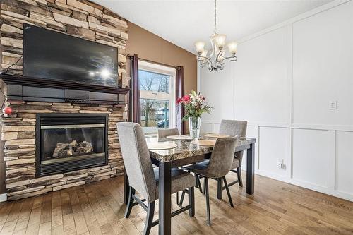 193 Beckinsale Bay, Winnipeg, MB - Indoor Photo Showing Dining Room With Fireplace