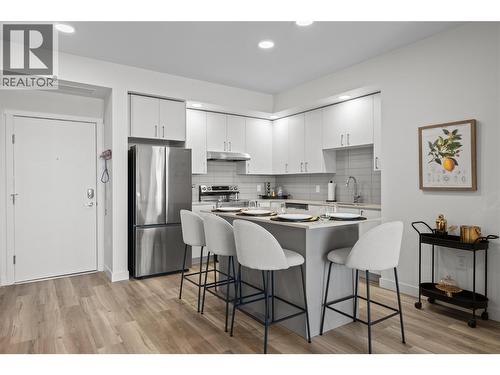 Foyer & Kitchen- Photos are of a similar home; some features may vary - 1111 Frost Road Unit# 308, Kelowna, BC - Indoor Photo Showing Kitchen With Stainless Steel Kitchen With Upgraded Kitchen