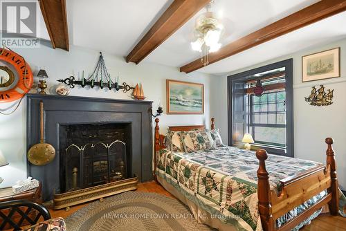 495 King Street W, Prescott, ON - Indoor Photo Showing Bedroom With Fireplace