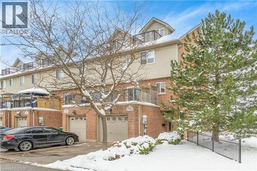 View of front of property with brick siding, a balcony, and a garage - 33 Wellington S, Cambridge, ON - Outdoor