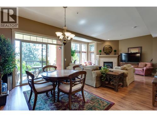 1795 Country Club Drive Unit# 105, Kelowna, BC - Indoor Photo Showing Dining Room With Fireplace