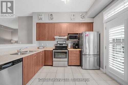 411 - 1440 Main Street E, Milton, ON - Indoor Photo Showing Kitchen With Double Sink