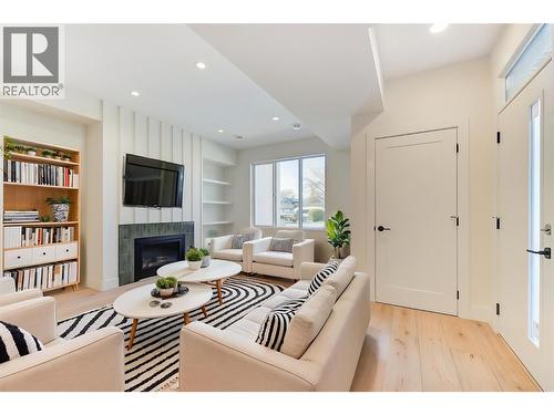 Virtually staged with fun design ideas - 857 Kinnear Court, Kelowna, BC - Indoor Photo Showing Living Room With Fireplace