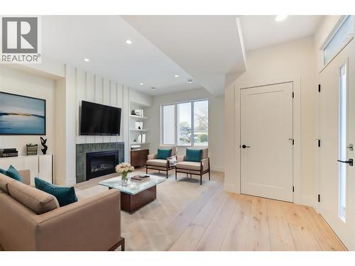 Virtually staged with fun design ideas - 857 Kinnear Court, Kelowna, BC - Indoor Photo Showing Other Room With Fireplace