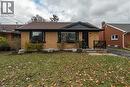 View of front facade with a front yard, brick siding, covered porch, a chimney, and roof with shingles - 266 Melrose Avenue, Kitchener, ON  - Outdoor 