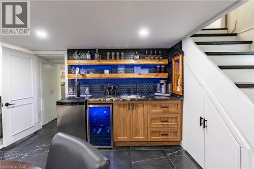 Indoor wet bar featuring open shelves, brown cabinets, wine cooler, and stairway - 266 Melrose Avenue, Kitchener, ON - Indoor Photo Showing Other Room