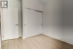 Unfurnished bedroom with a closet and light wood-style flooring - 