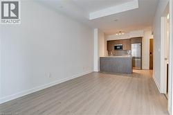 Unfurnished living room with light wood finished floors and baseboards - 