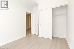 Unfurnished bedroom with light wood-style floors and a closet - 