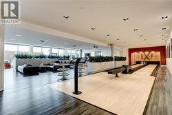 Gym with bowling, a wall of windows, and recessed lighting - 